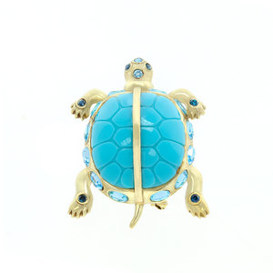 TORTUGA - TORTUGA is a brooche with the shape of a little turtle to wear it always to catch all the good vibrations! it's a jewel made of light gold and acquamarina, with sapphire and aquamarina stones. - A.Z. Bigiotterie