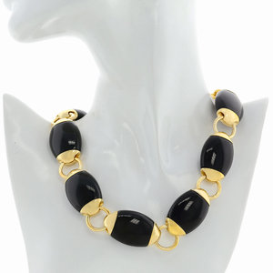 BEATLE - BEATLE is a wonderful choker made of light gold that emphasizes your cleavage. The black resins elements seem like funny beatles that chase on the chain! - A.Z. Bigiotterie