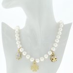 Light gold and rodhium with crystals, black cabuchon and stones and white pearls